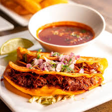 Sandbar Cocina y Tequila signature dishes Blazin' Fajitas al CarbonBirria Crusty Queso TacosEl Supreme Burrito